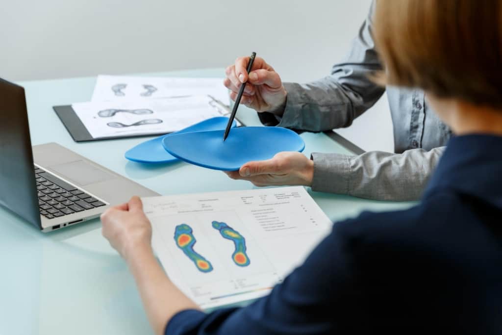 Podiatrist showing how custom foot orthotics work